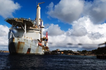 Dove under the oil drilling ship